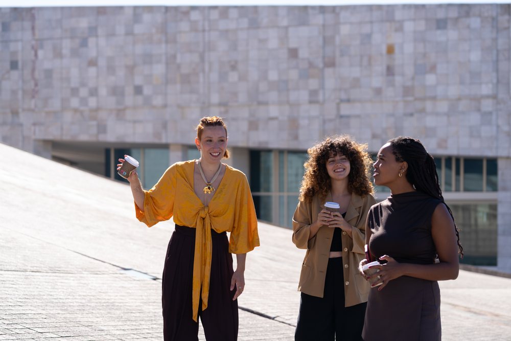 Three African American and white women chatting outdoors