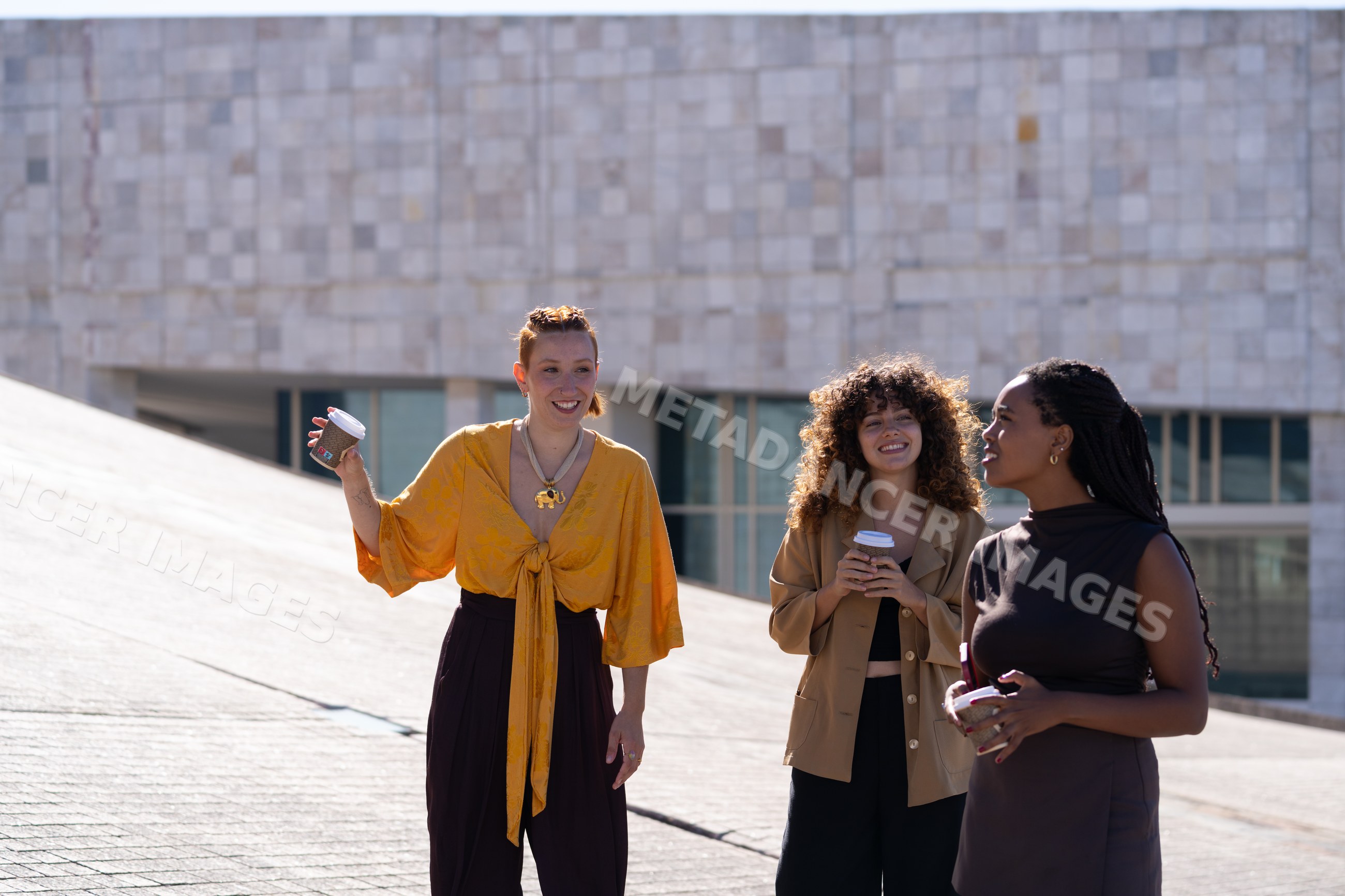 Three African American and white women chatting outdoors