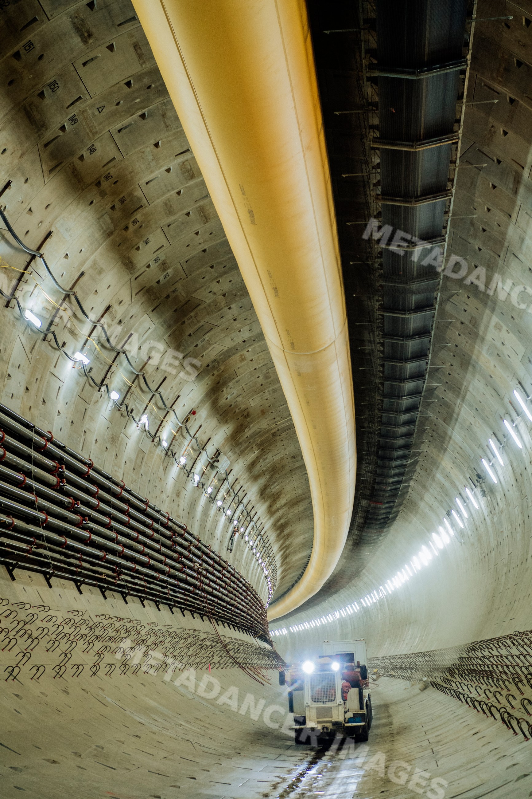Construction vehicle working inside curved tunnel during drilling