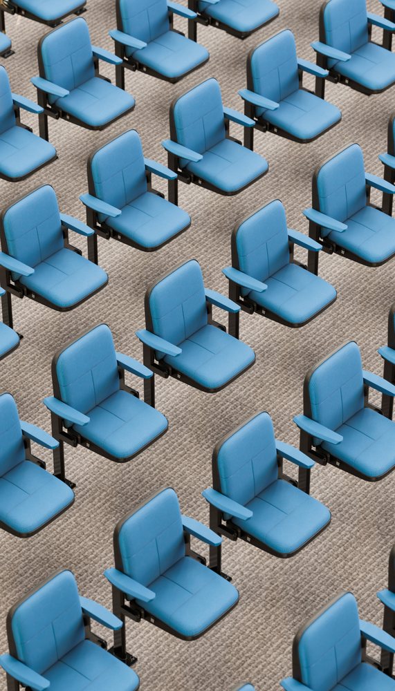 Rows of blue auditorium chairs in conference hall