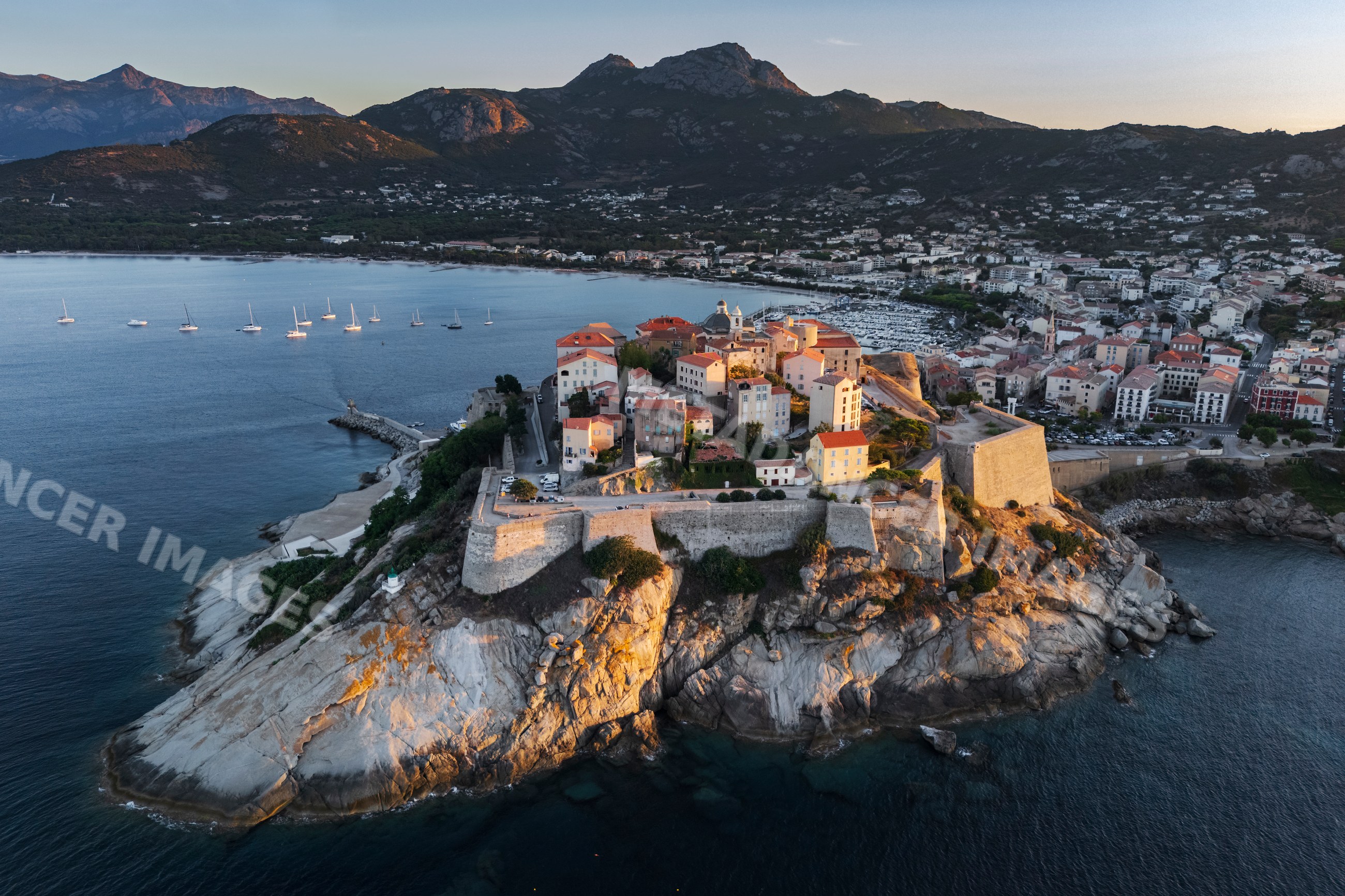 Citadel of Calvi on rocky coast at Sunset in corsica, france