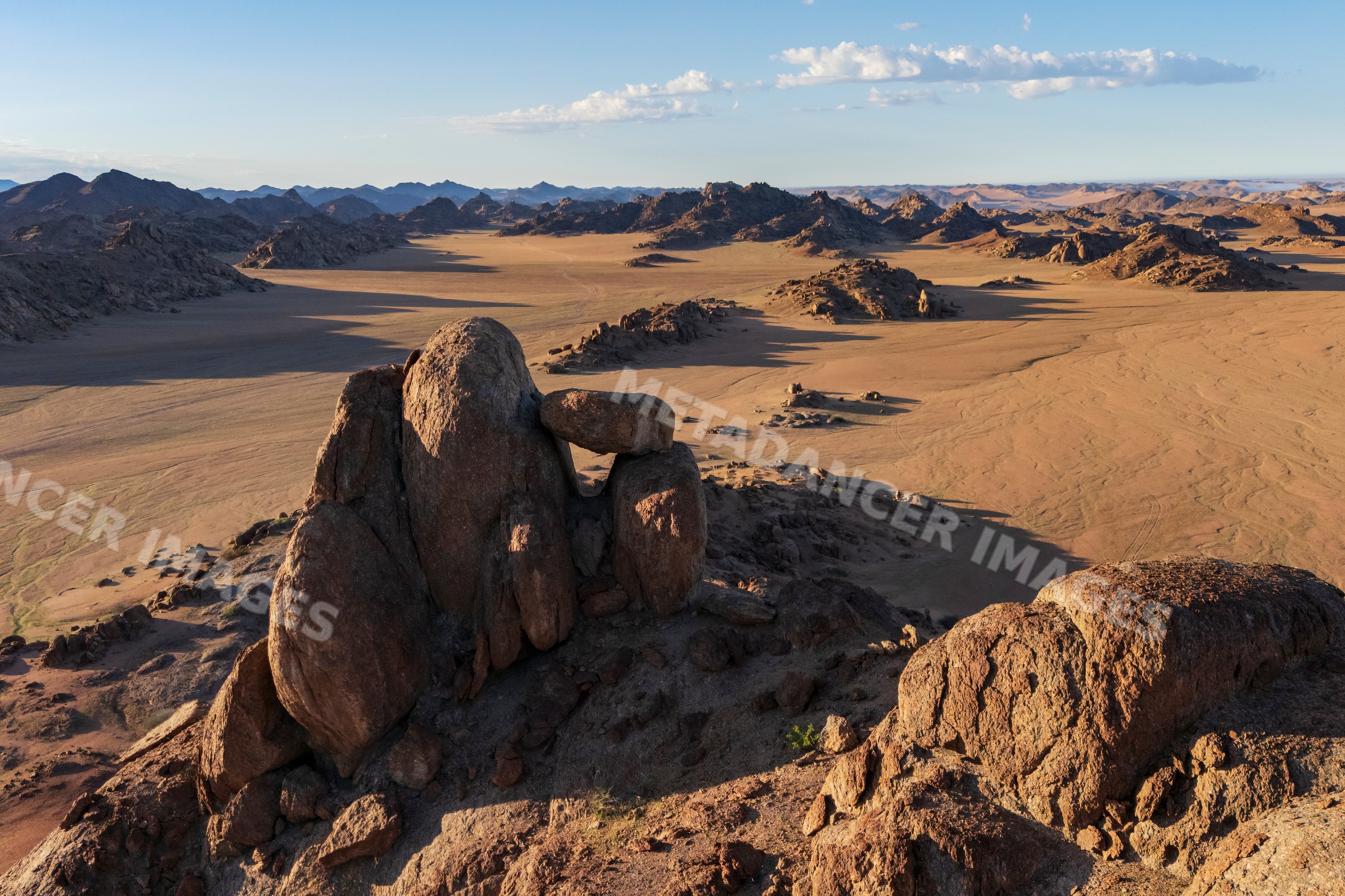 Balanced rock formation at Sunrise in namibian desert valley
