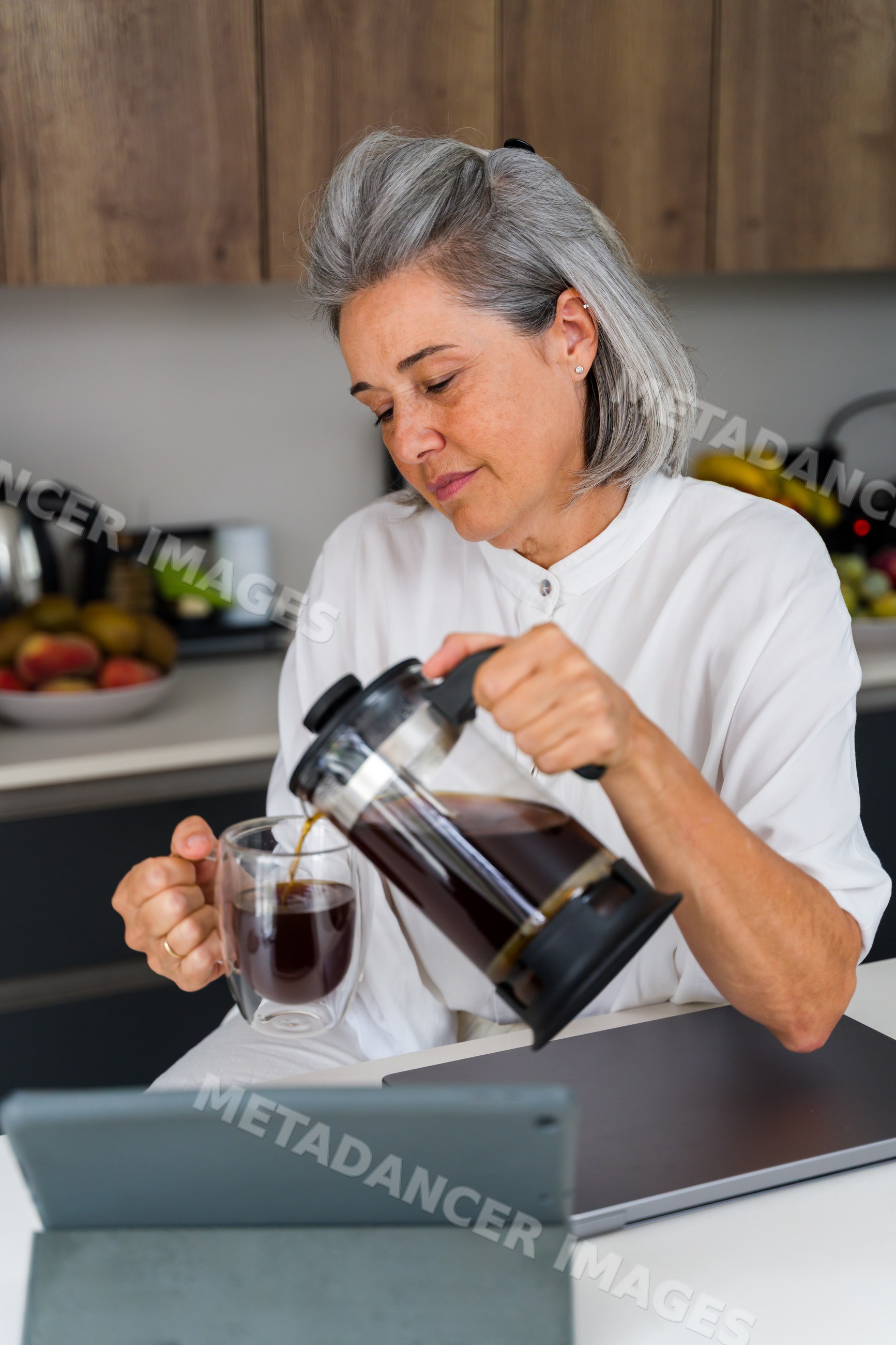 White Woman pouring coffee from french press