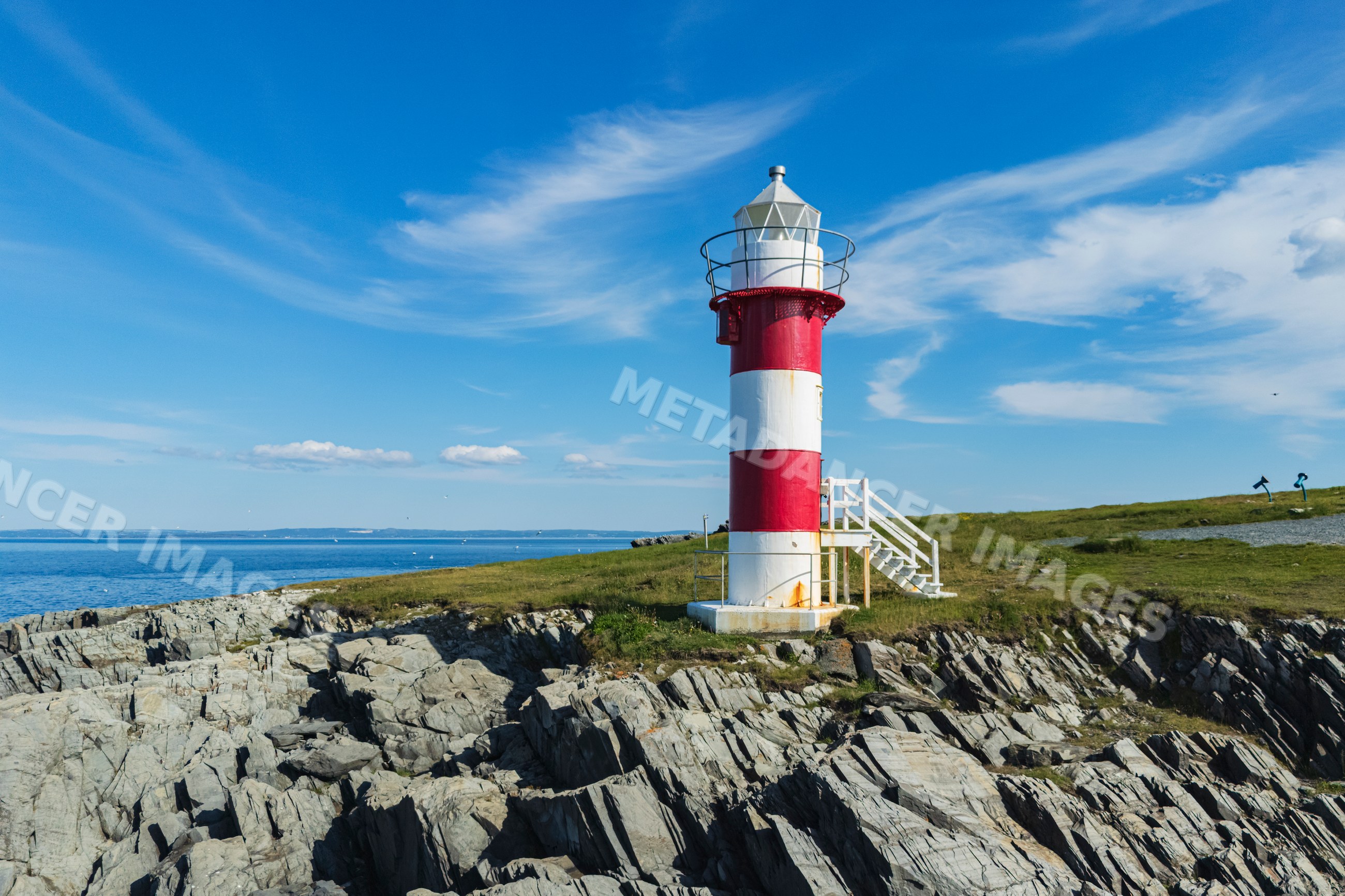 Green Point Lighthouse on rocky coast in port de grave, Newfoundland