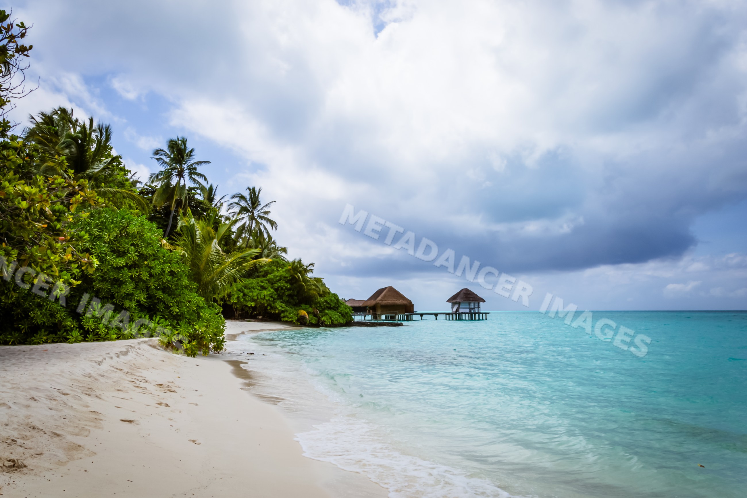 Tropical beach with overwater bungalows in a beach