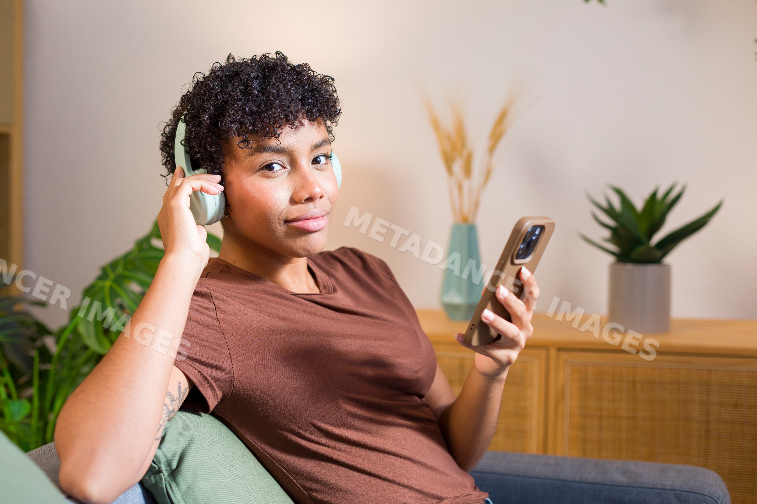 Young African American woman listening to music with headphones
