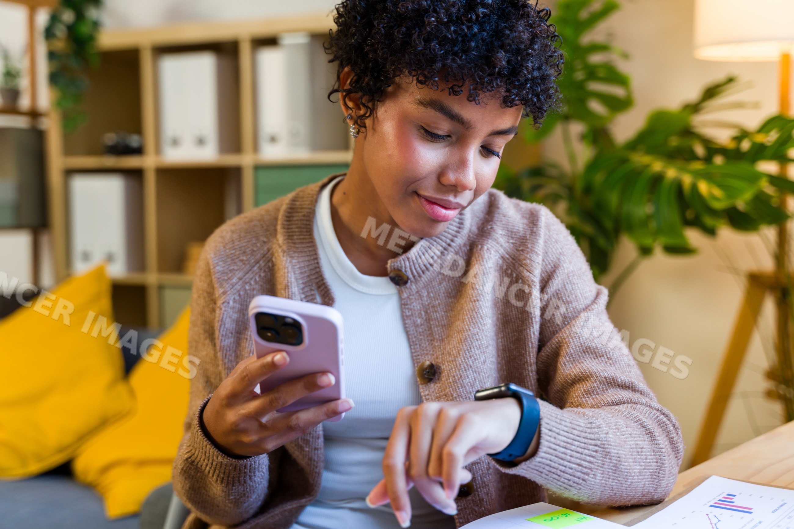 African American woman using smartphone and smartwatch