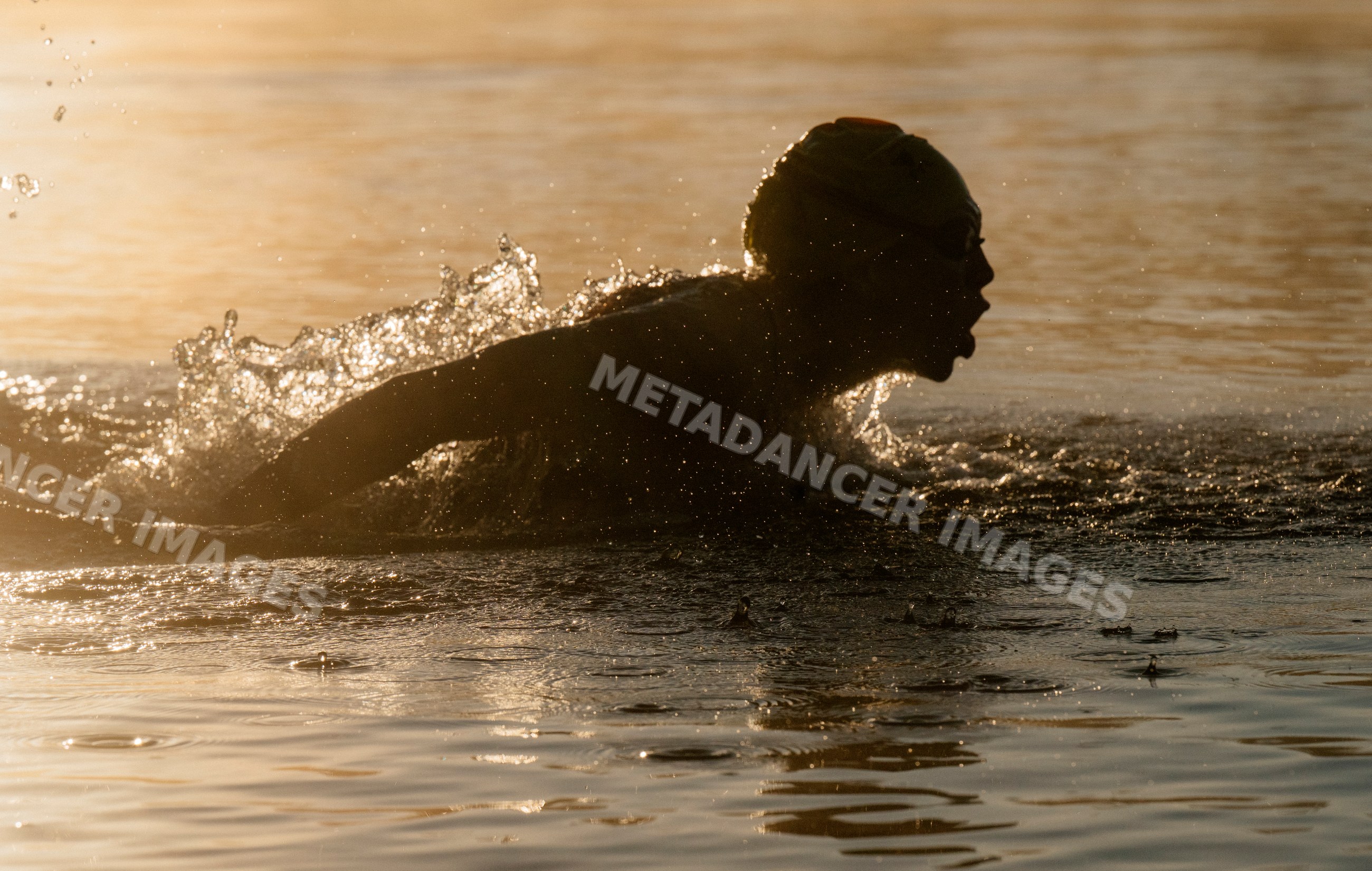 White swimmer performing breaststroke with water splash
