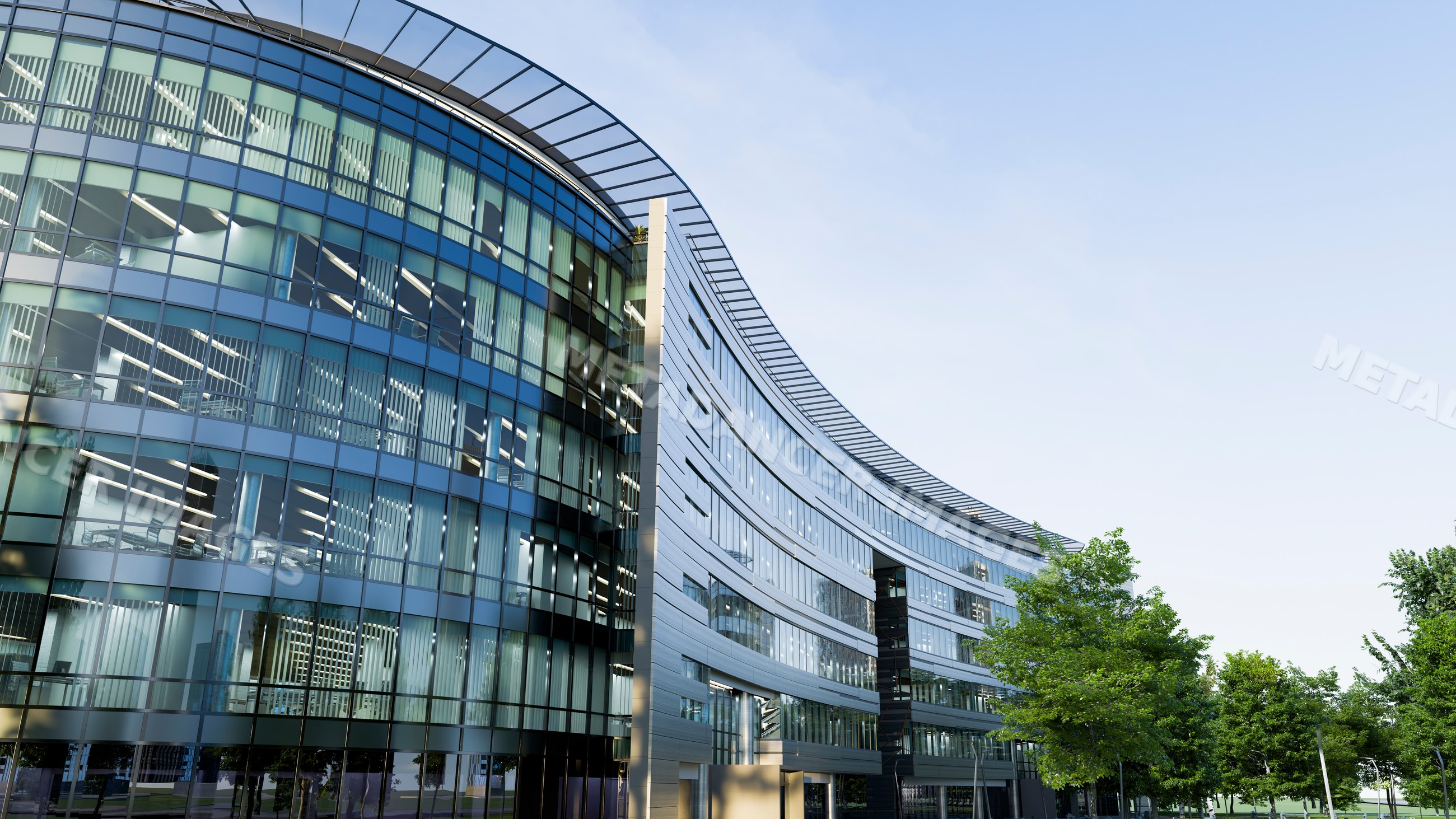 Modern office building with curved glass facade and outdoor greenery
