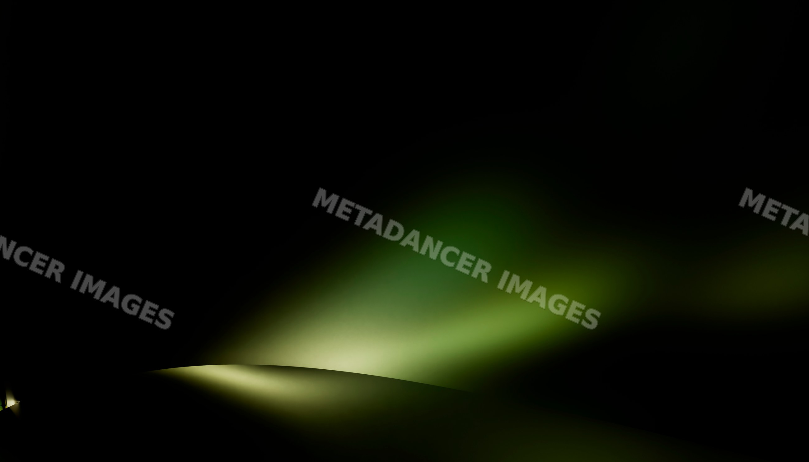 Soft green light fading into darkness creates an abstract background
