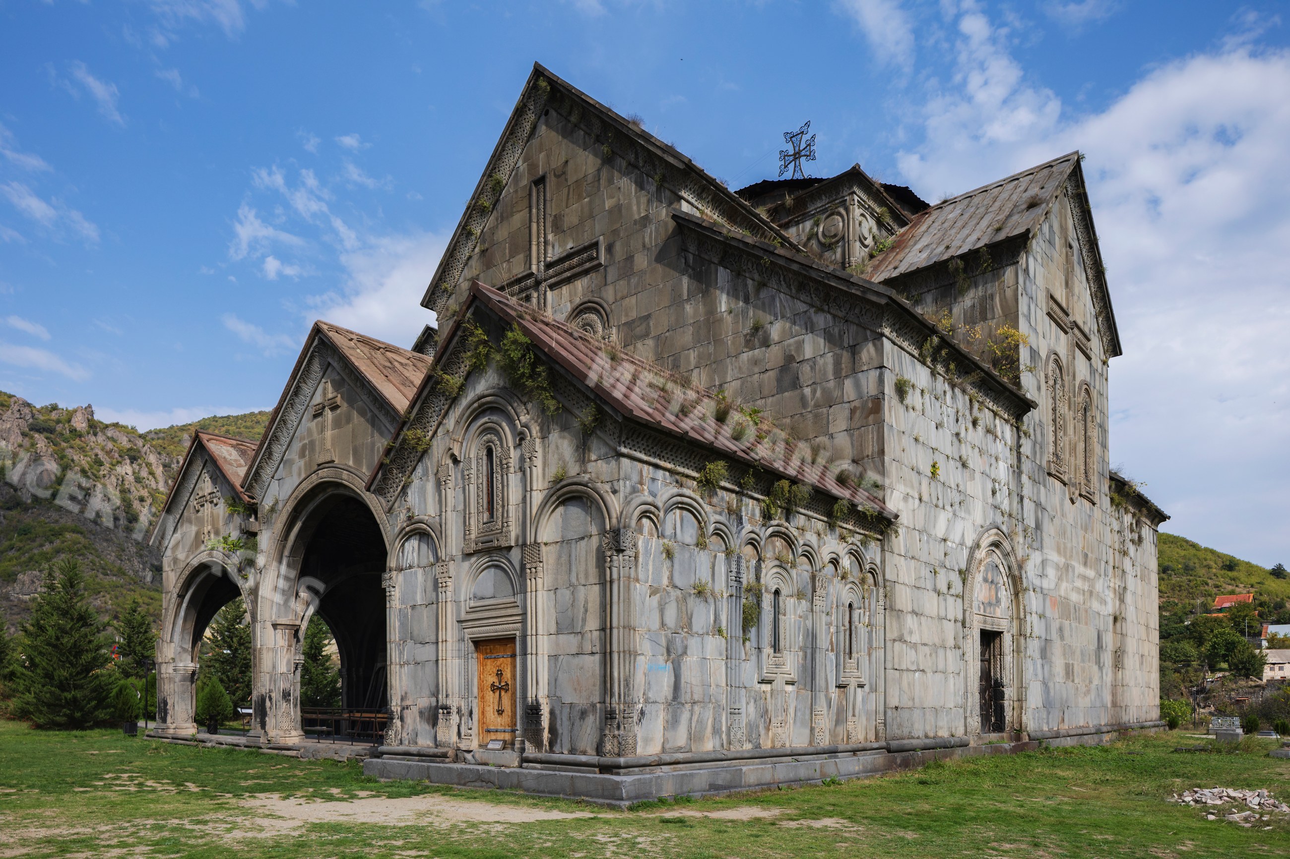 Front facade of Akhtala Monastery with stone arches