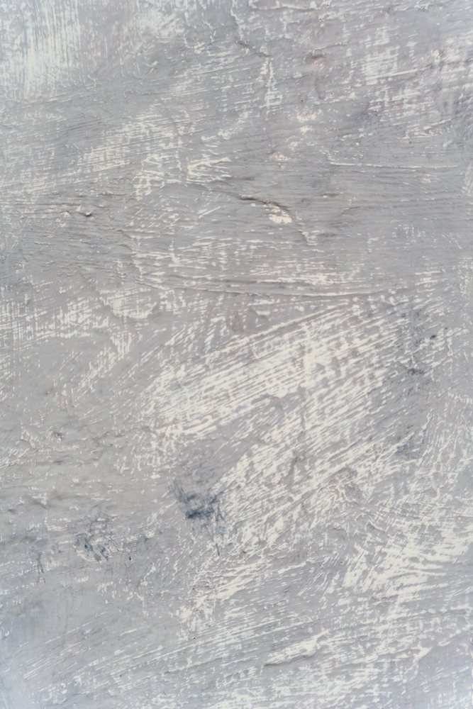 Abstract gray textured surface with scratched paint marks