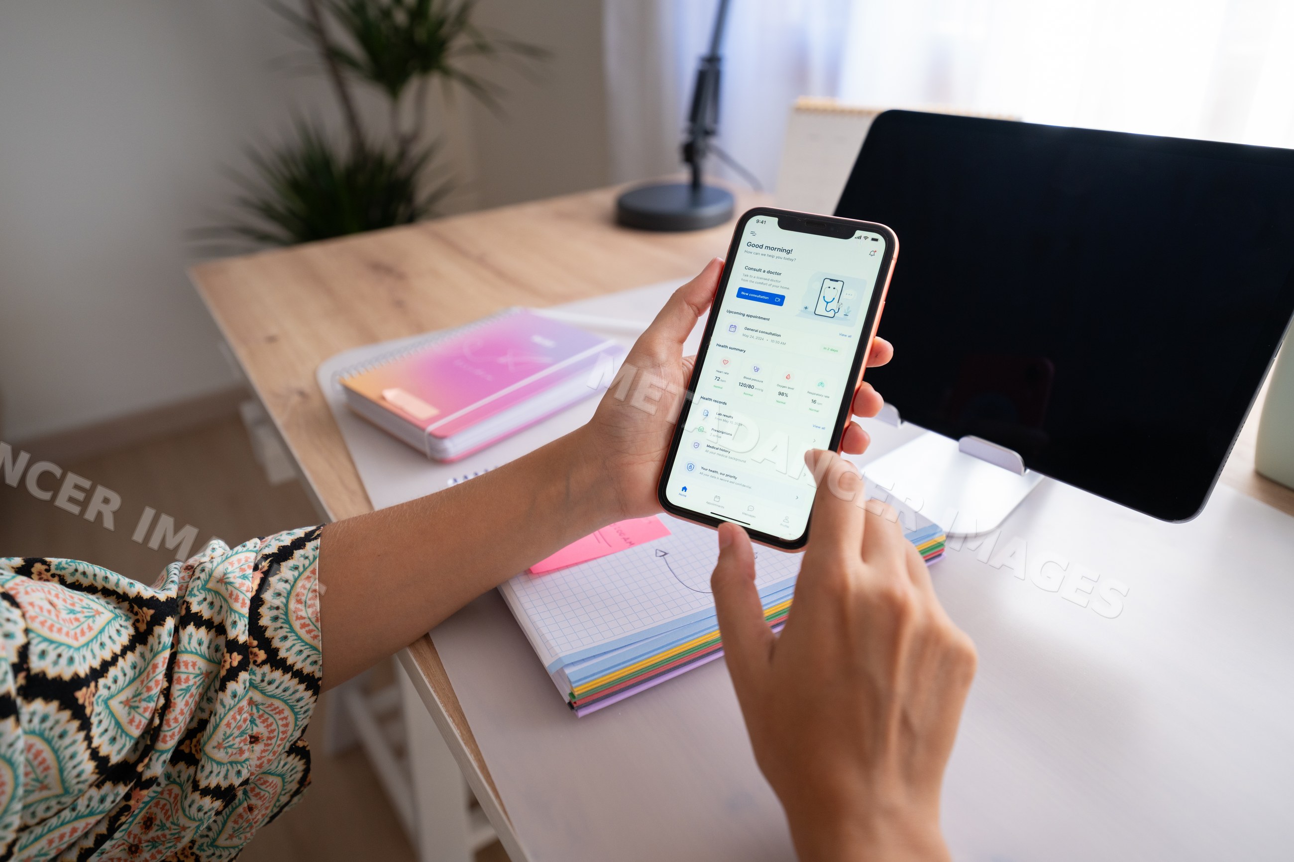 White woman using smartphone with digital health app in home office