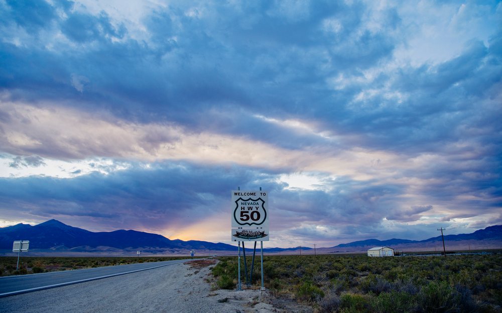 Nevada highway 50 sign in desert landscape at sunset