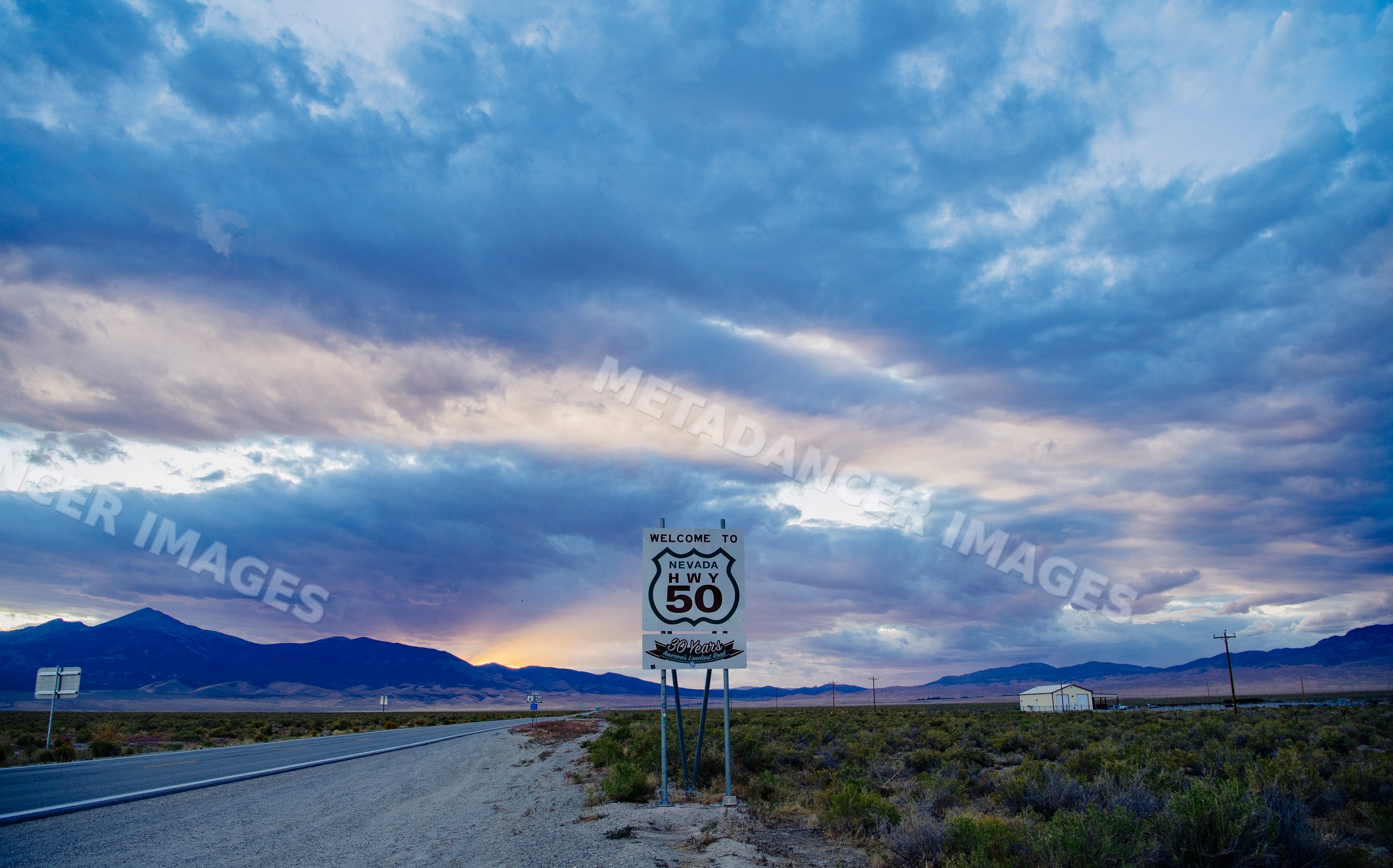 Nevada highway 50 sign in desert landscape at sunset