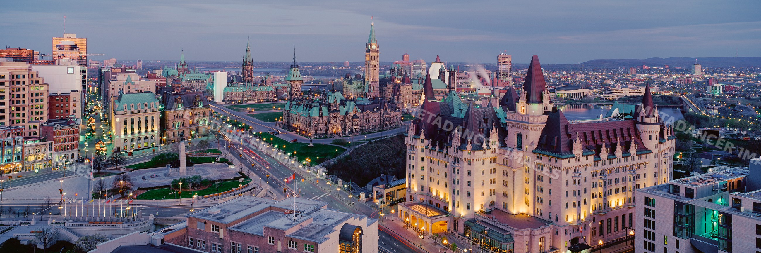 Ottawa parliament buildings illuminated at dusk with city skyline