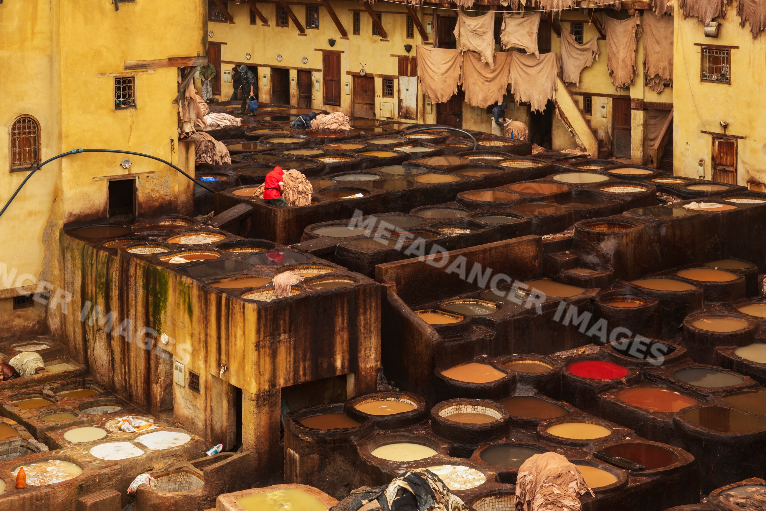 Chouara tannery leather dyeing vats in Pouring Rain in fes Morocco