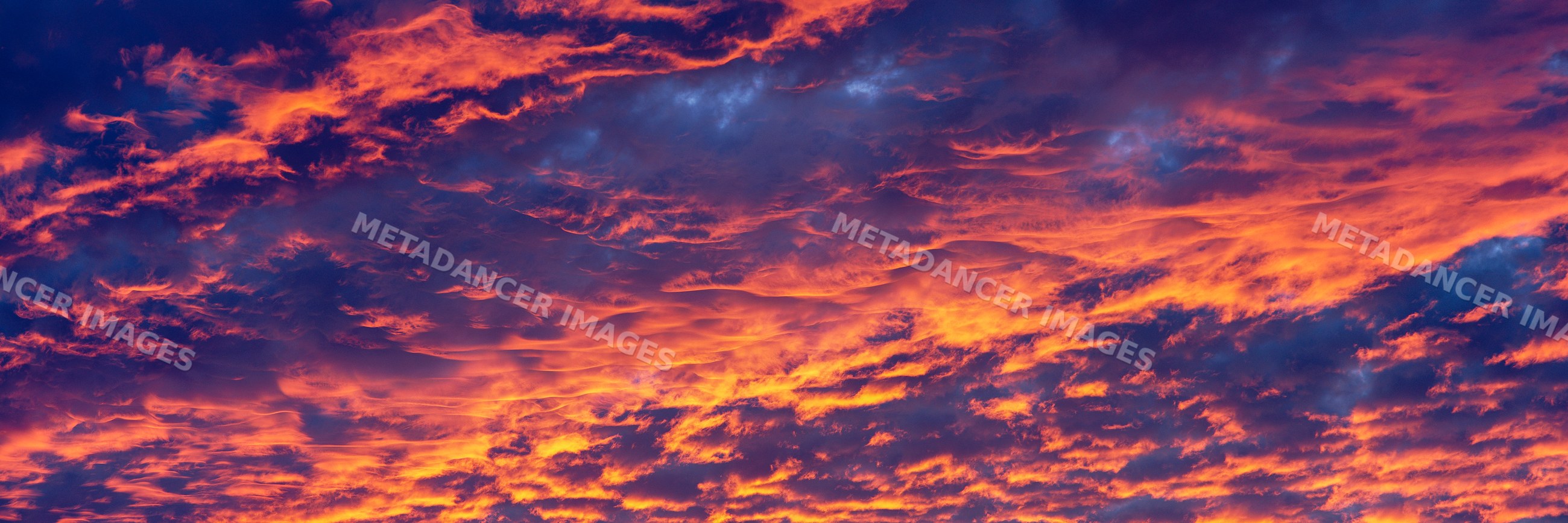 Dramatic orange and purple clouds in sunset sky