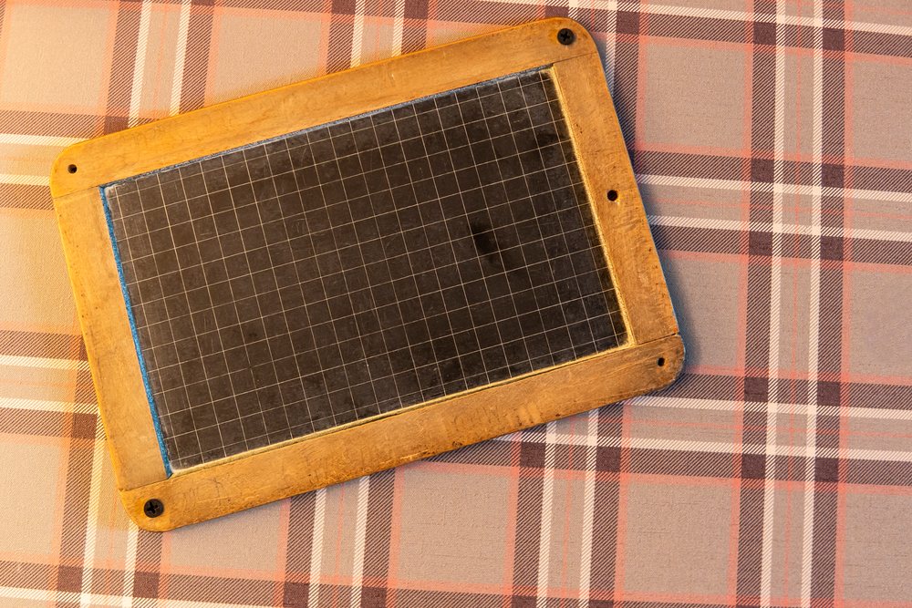 Vintage slate board with grid lines on plaid fabric in Verdun, France
