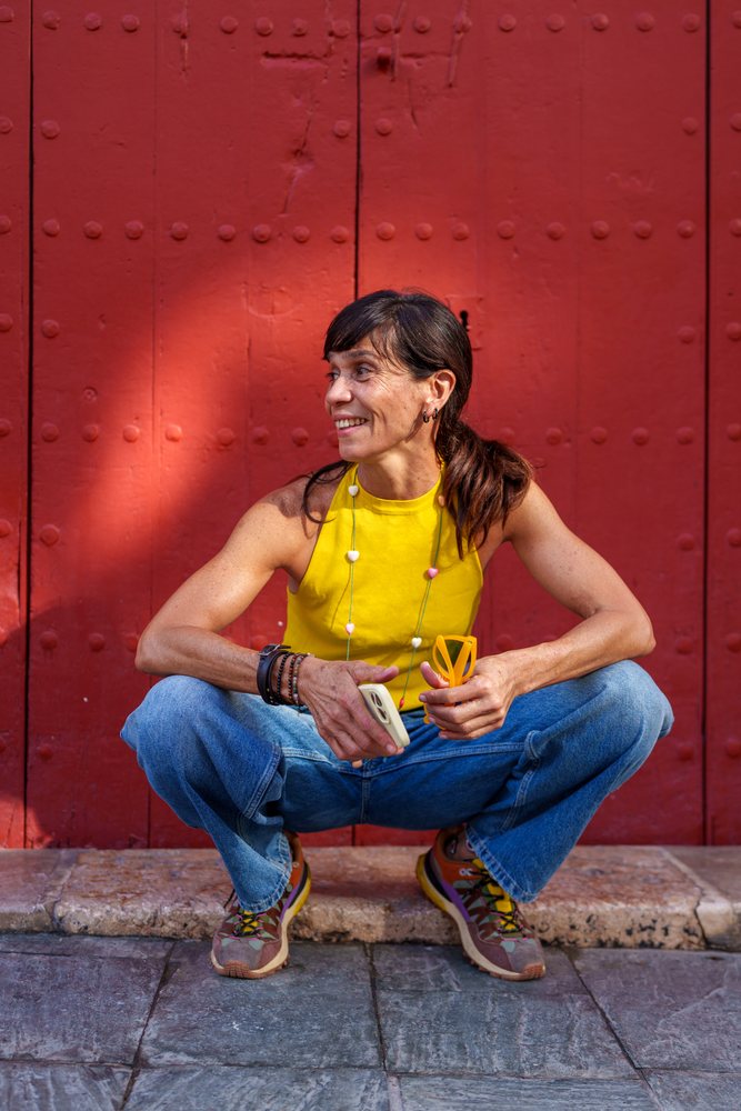 Hispanic woman squatting outdoors