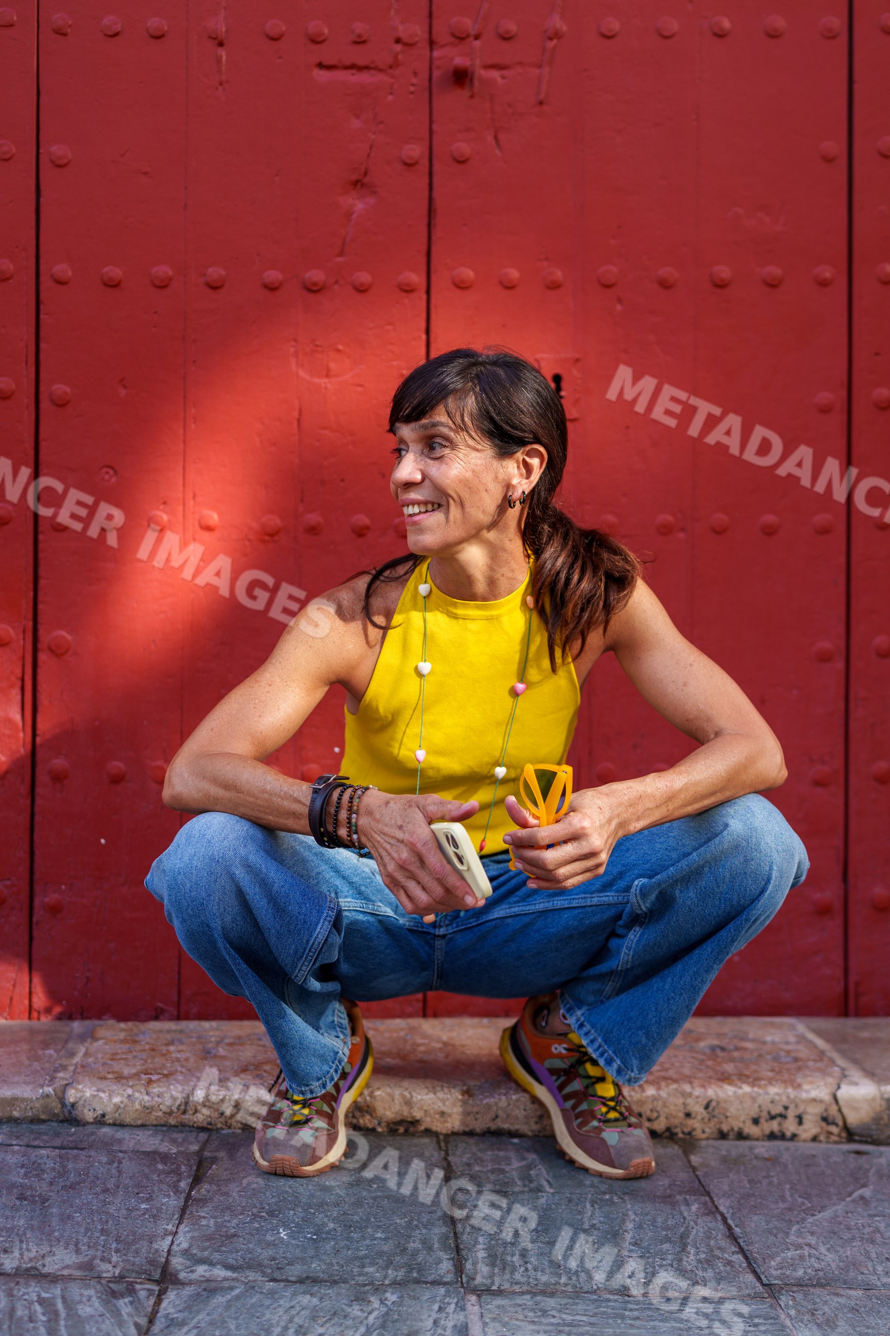 Hispanic woman squatting outdoors