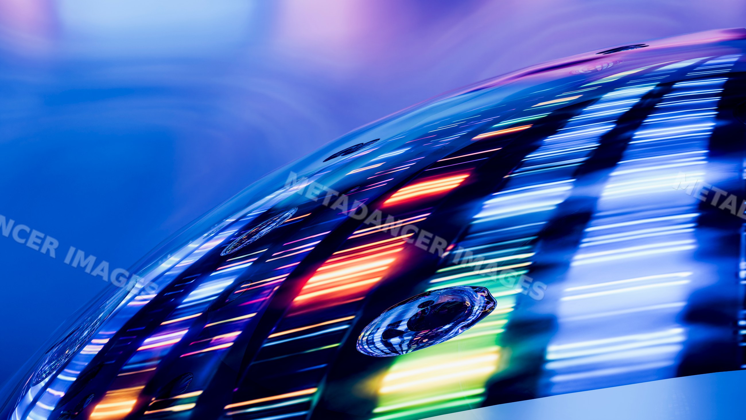 Colorful light reflection on curved glass surface with water droplets