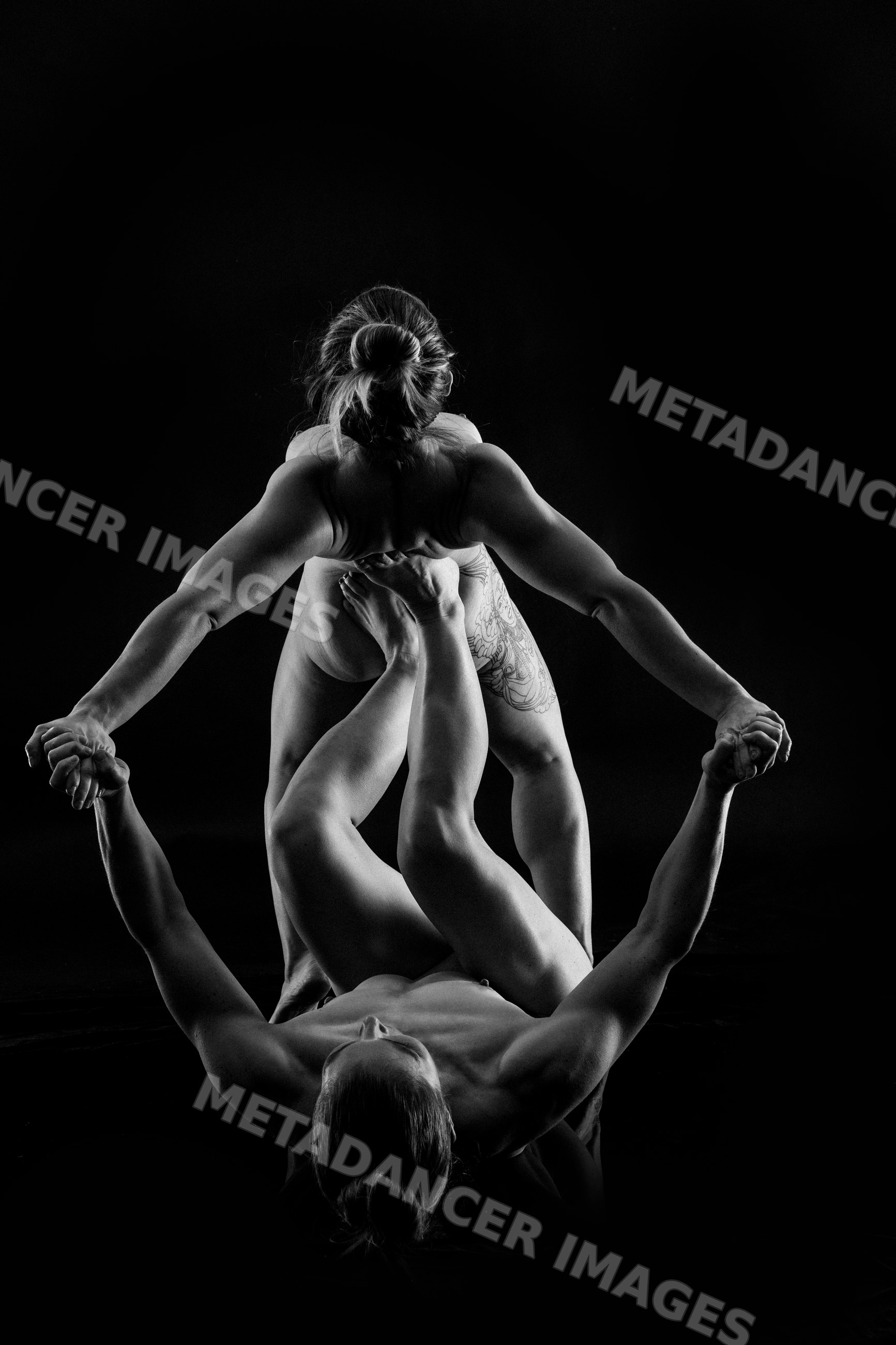Athletic partners performing yoga acrobatics pose