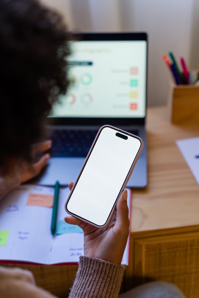 African American person holding smartphone working