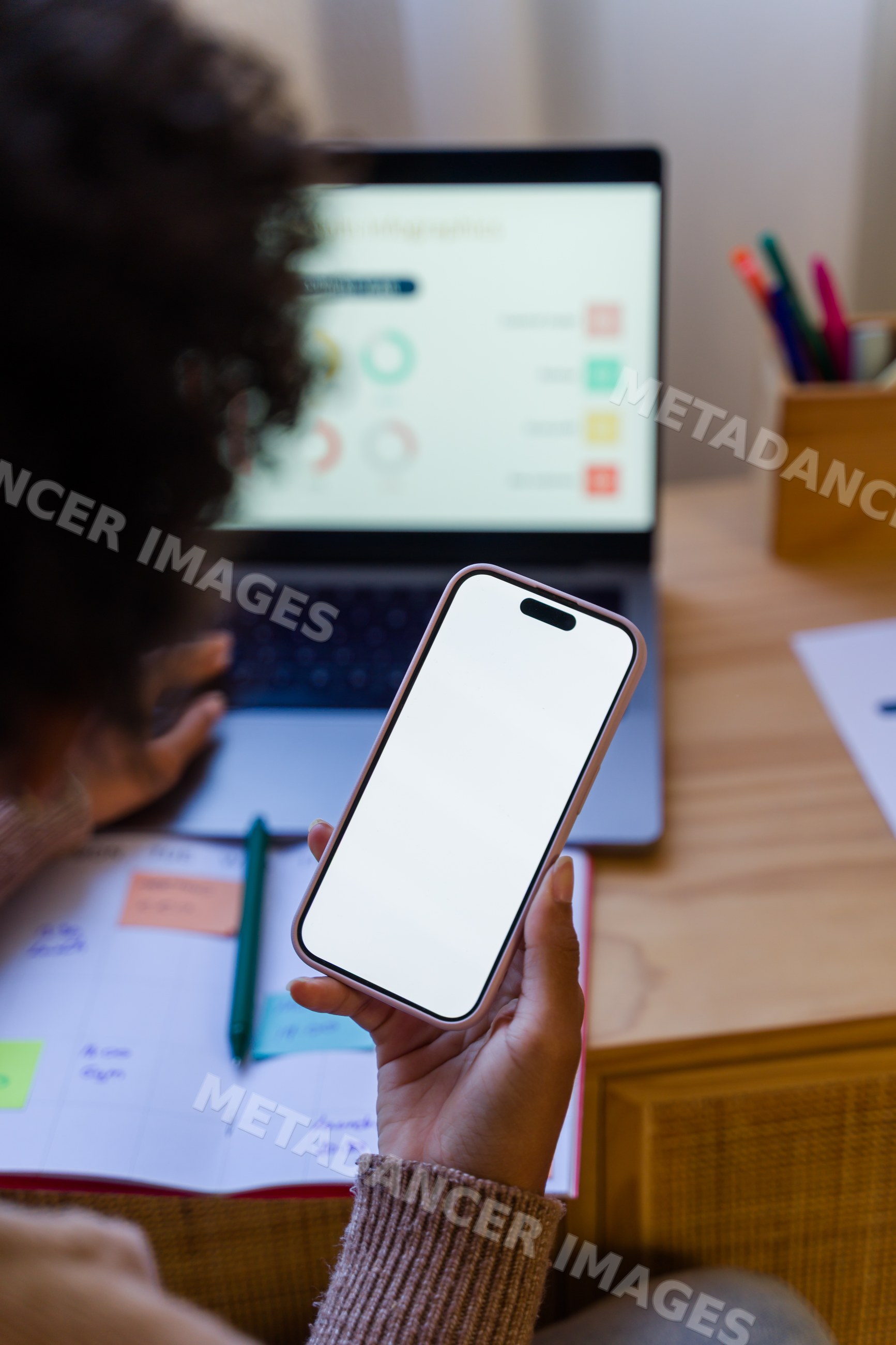 African American person holding smartphone working