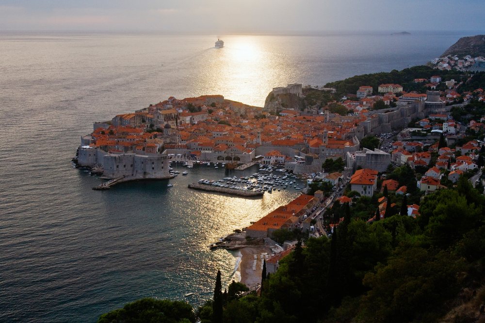 Old city of dubrovnik surrounded by walls at dusk on adriatic coast