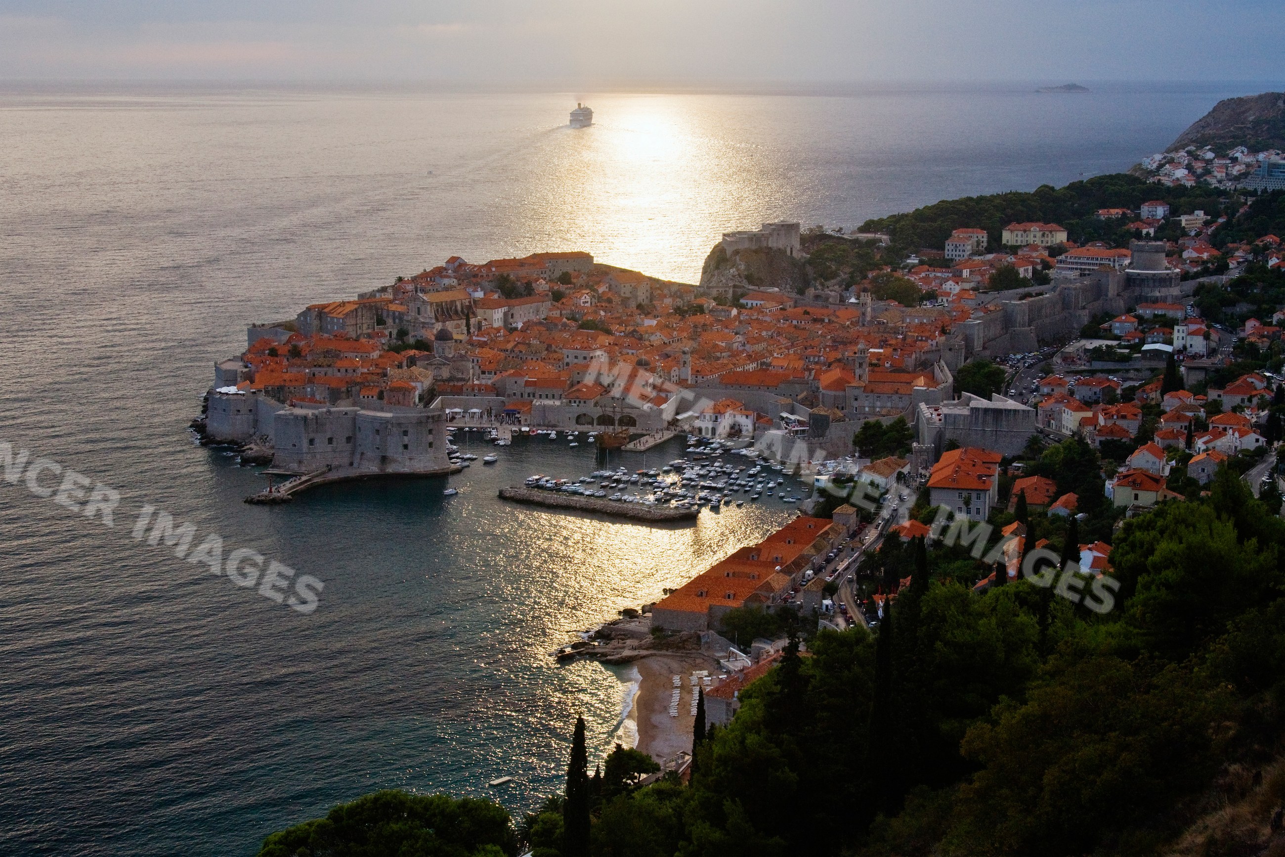 Old city of dubrovnik surrounded by walls at dusk on adriatic coast