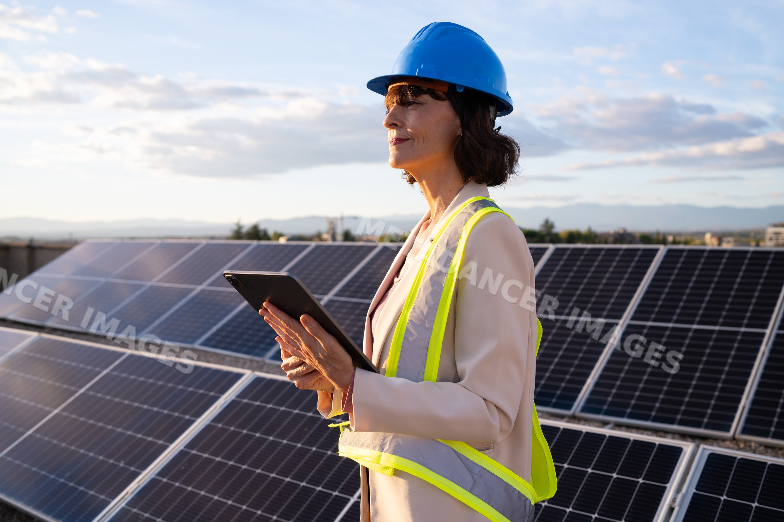 White woman inspecting solar panels holding tablet outdoors in Madrid