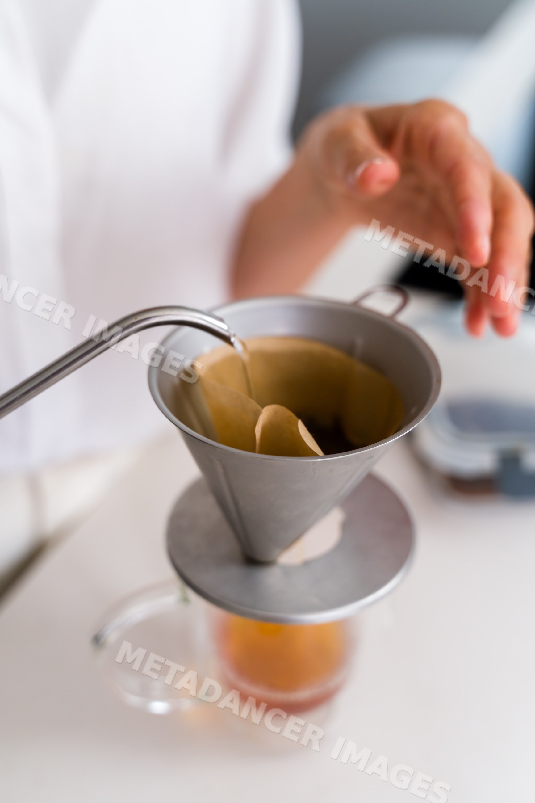 Pouring hot water into coffee filter for drip brewing