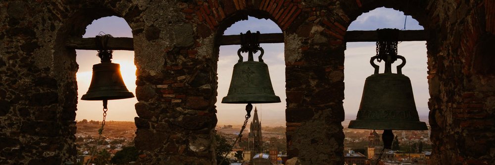 View through bell tower over san miguel de allende at sunset