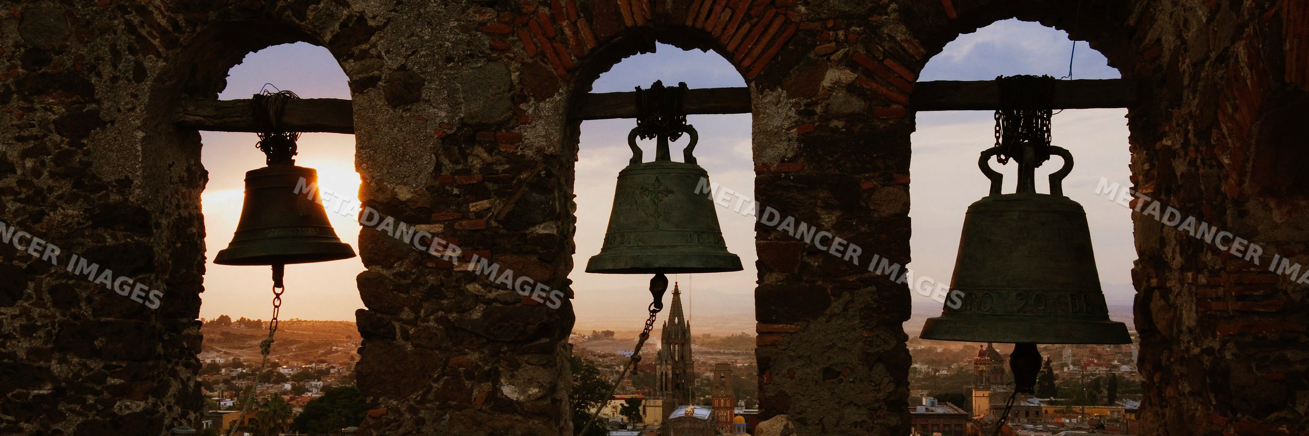 View through bell tower over san miguel de allende at sunset
