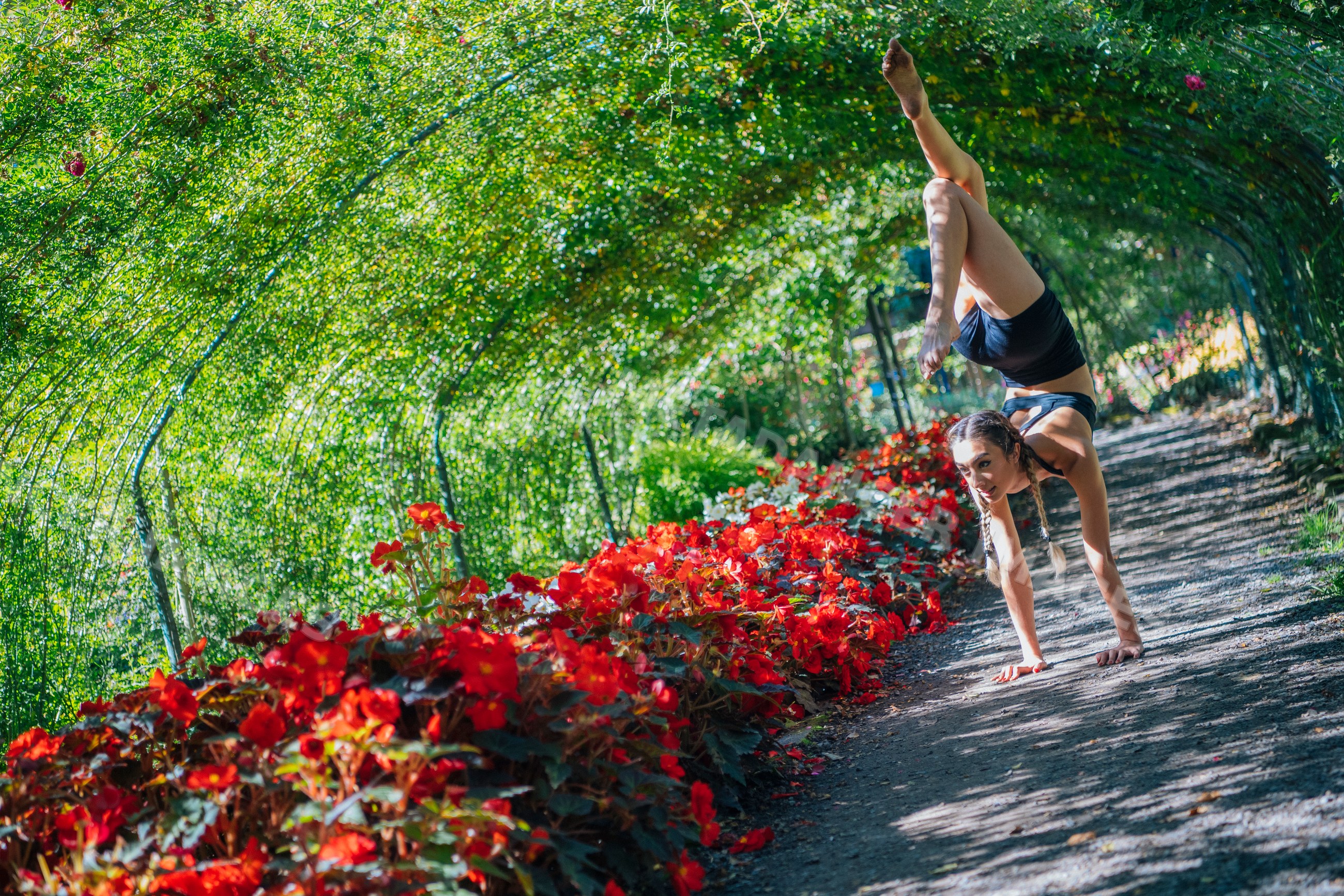 White woman contortionist doing handstand
