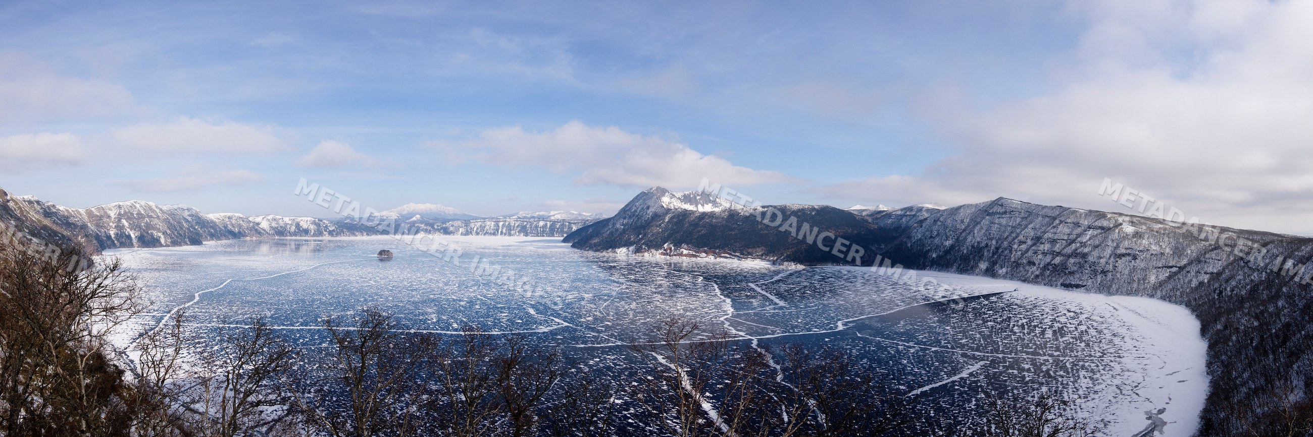 Frozen lake mashu with snow-covered mountains, japan