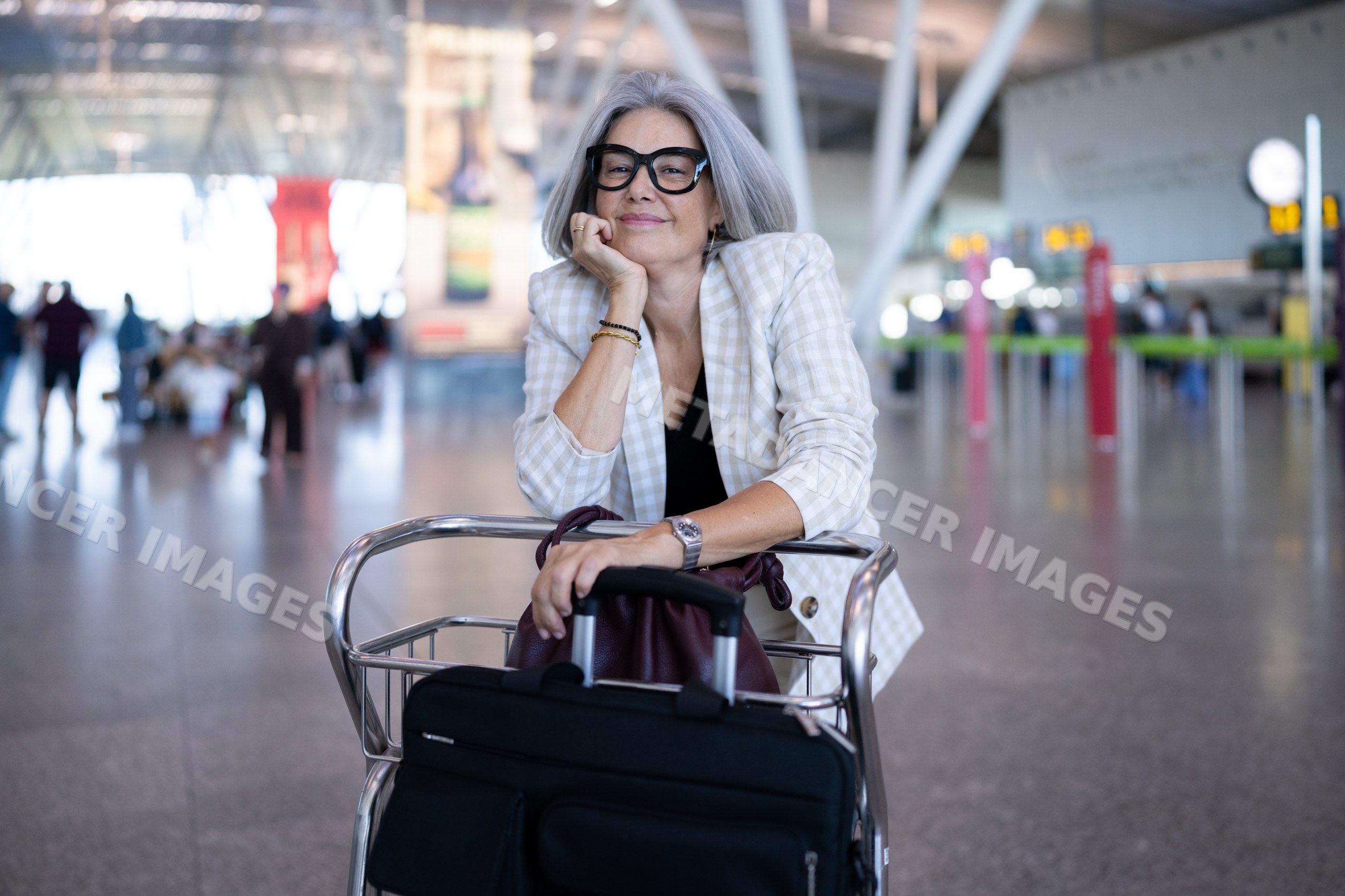 Businesswoman traveler with luggage at airport terminal in Madrid