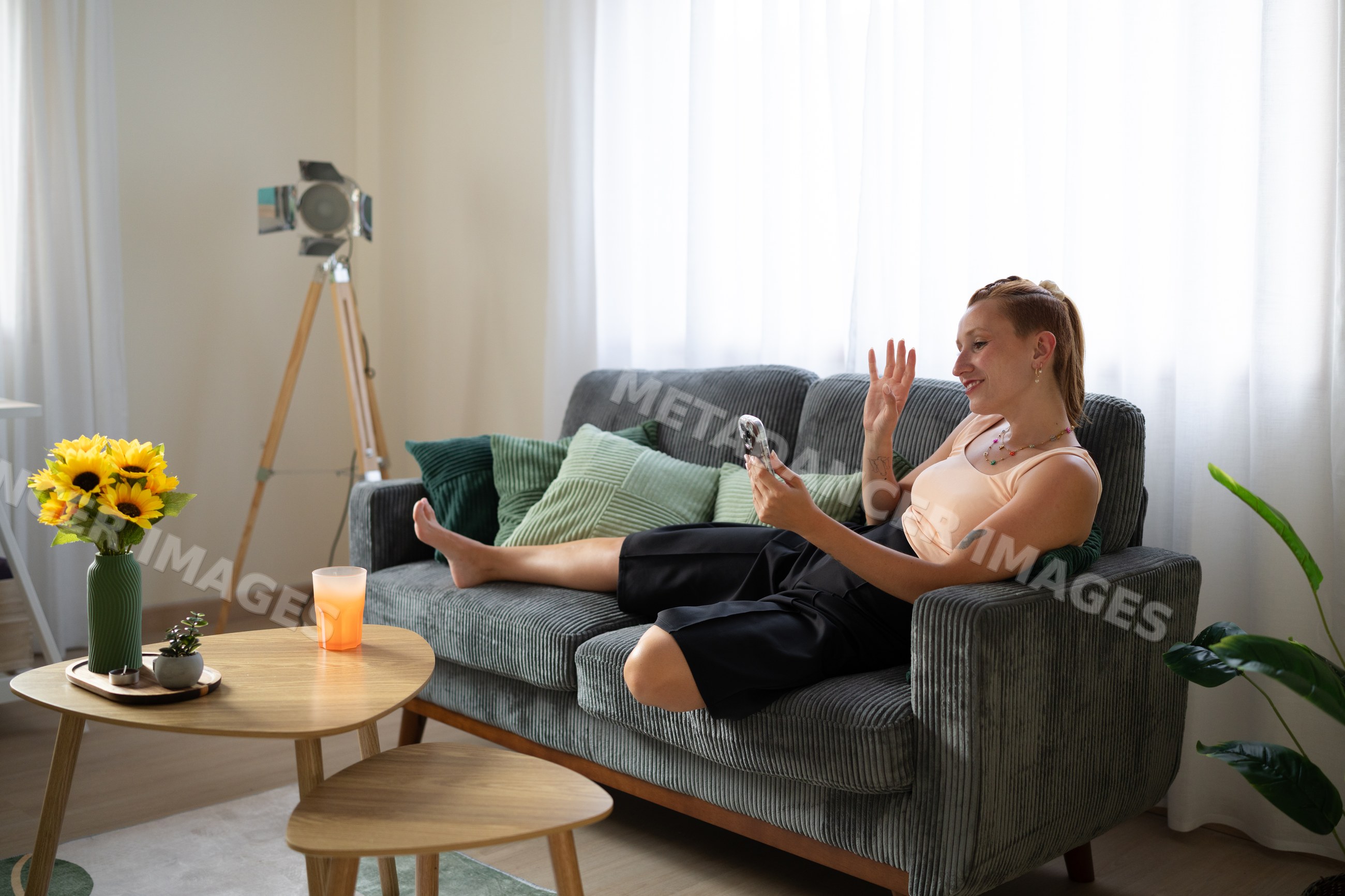 White Woman waving during a video call