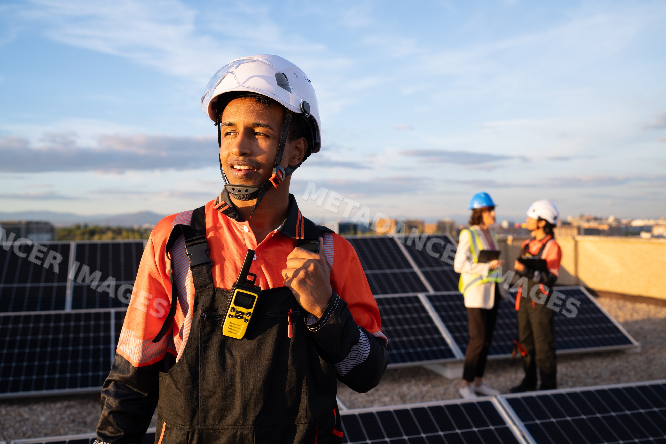 Solar technician on rooftop solar panels in Madrid, Spain