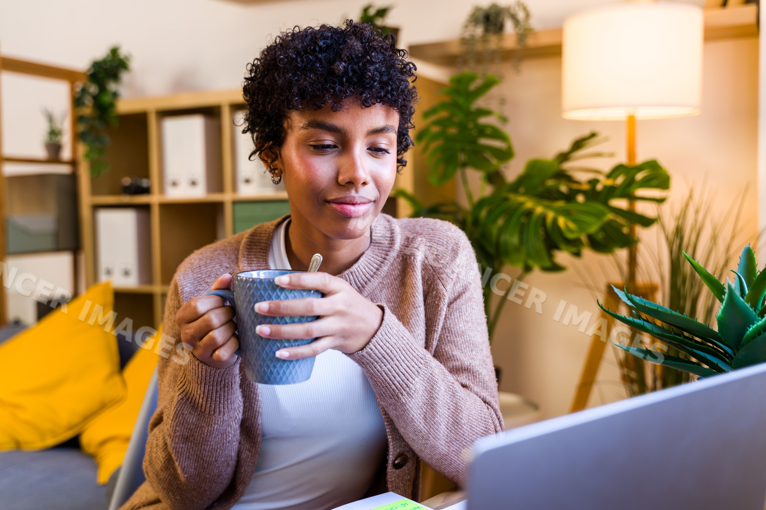 African American woman drinking coffee indoors