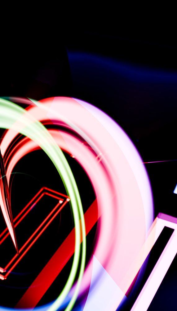 Abstract colorful neon light trails creating geometric shapes on dark