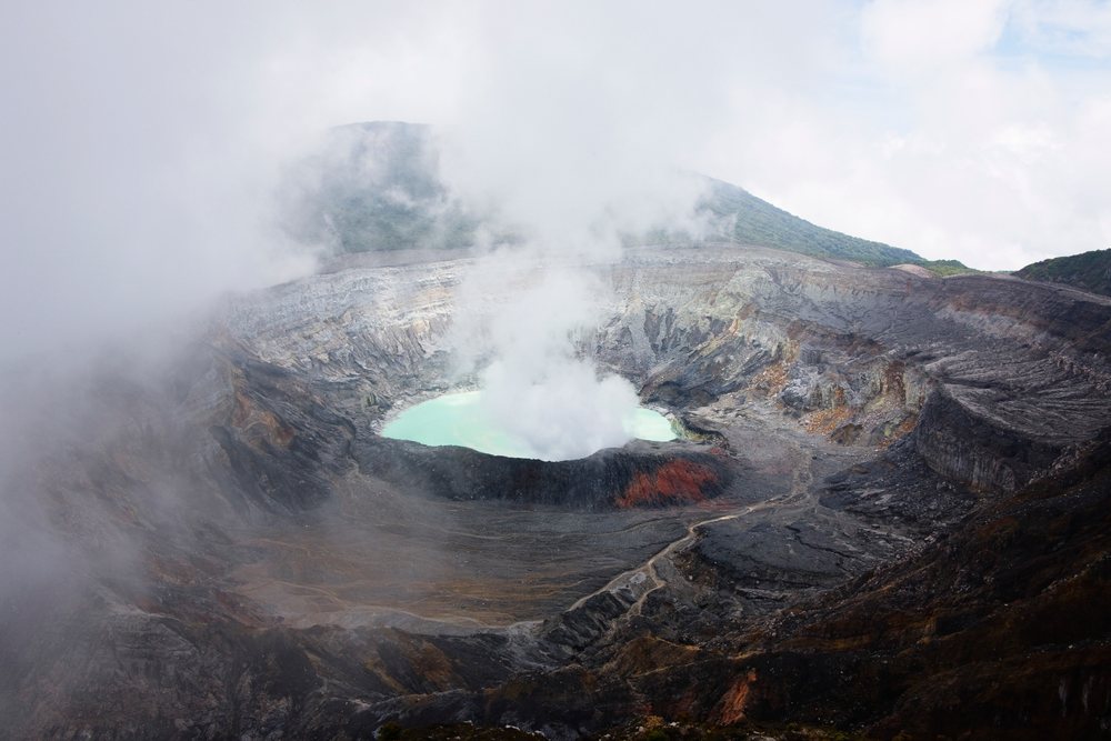 Poas volcano crater steaming in volcanic landscape