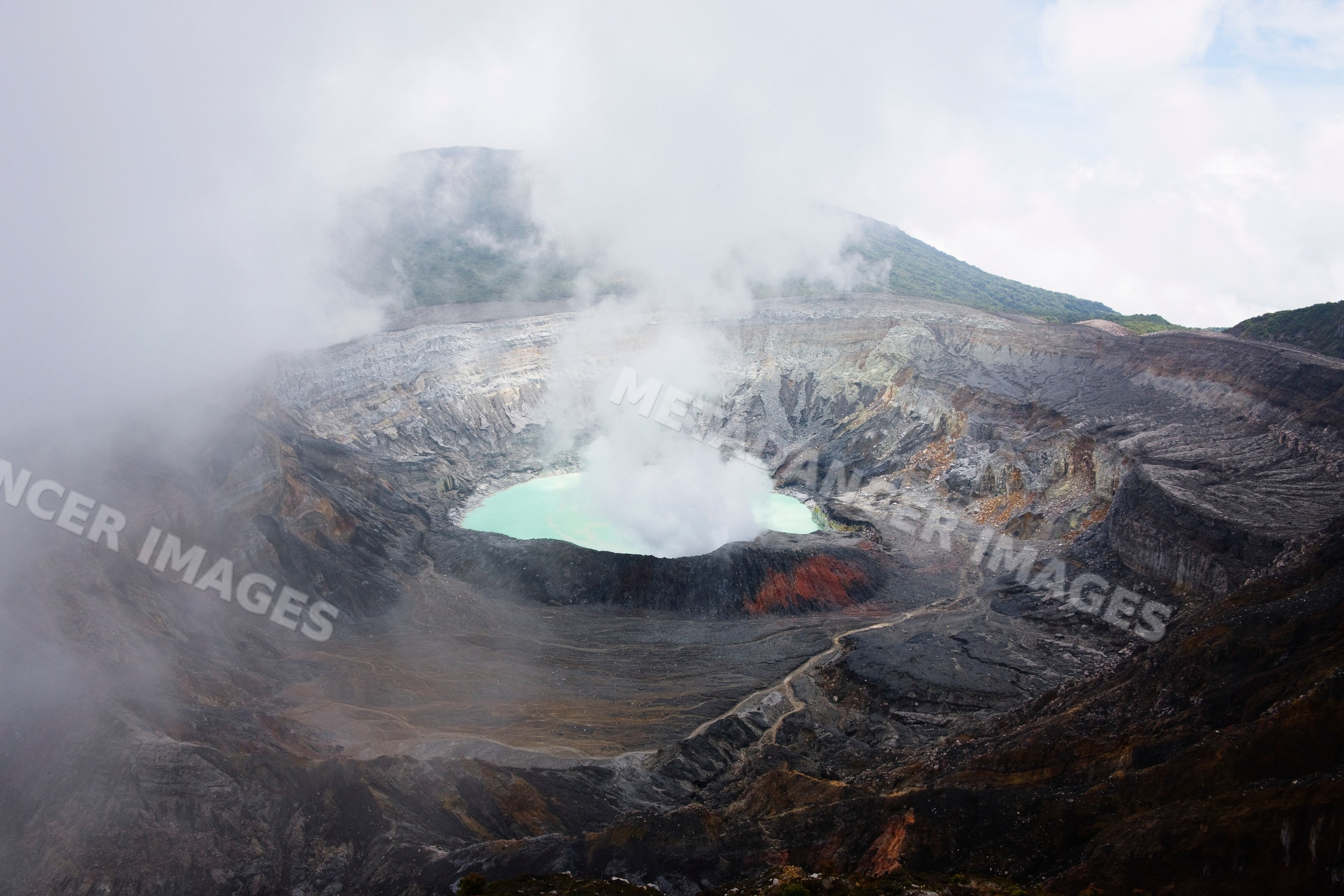 Poas volcano crater steaming in volcanic landscape