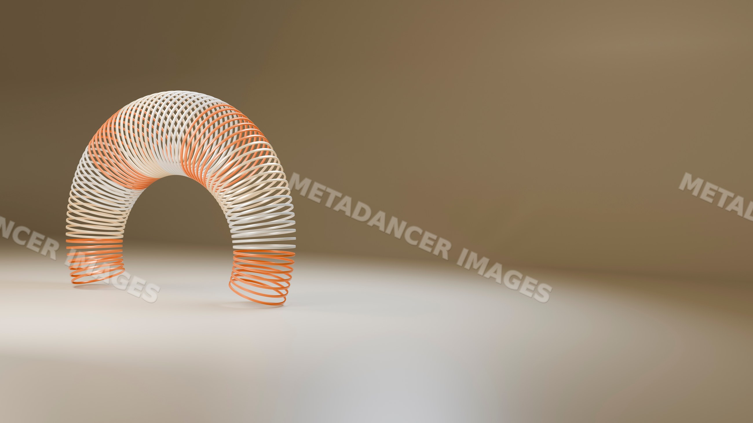 Curved orange and white spring toy in a studio setting