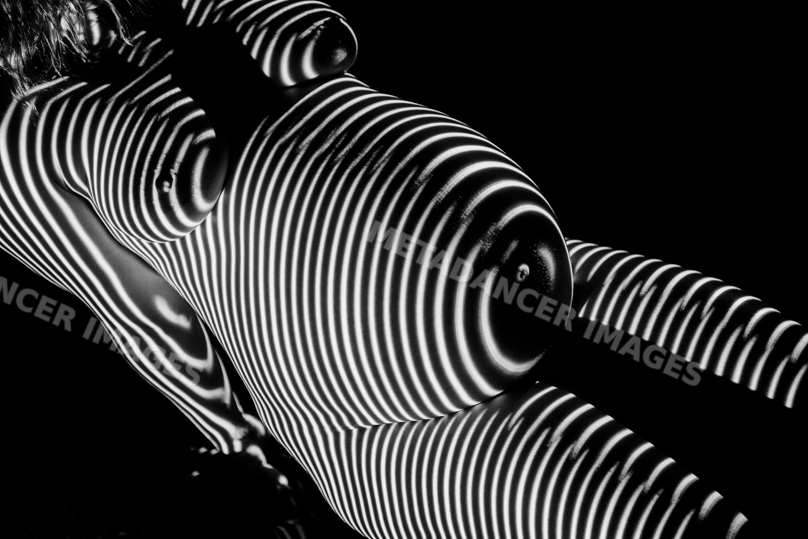 Pregnant white woman with striped light patterns on torso