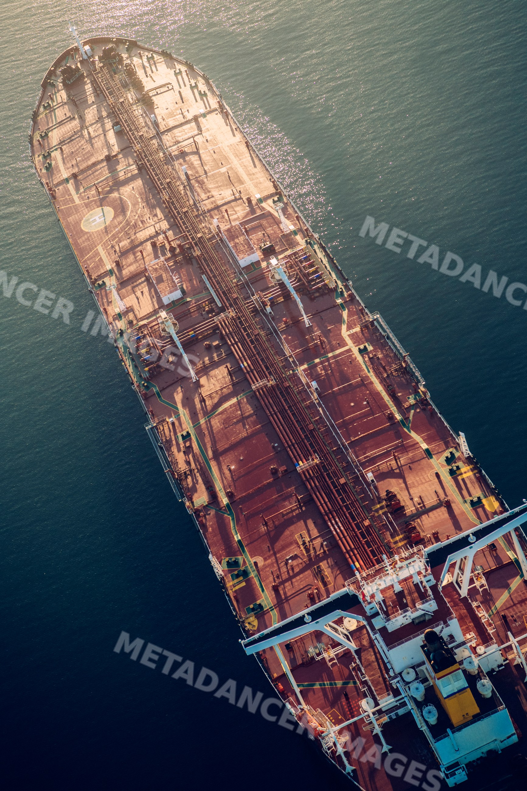 Oil tanker ship viewed from above on water in a beach