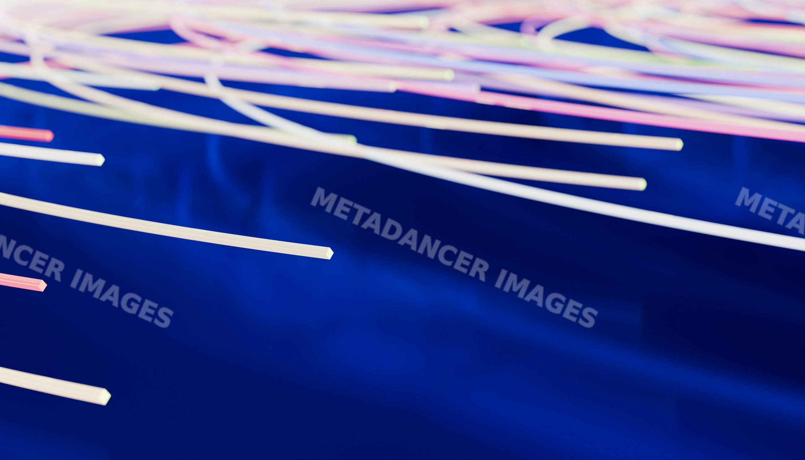 Fiber optic cables lit up over blue background in technology setting