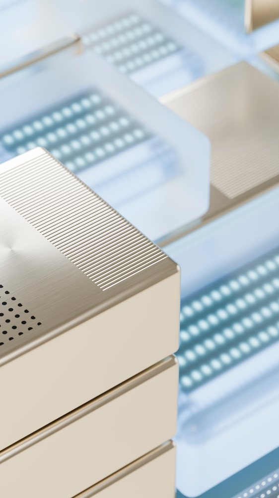 Close-up of gold-tone stacked electronic devices with metallic
