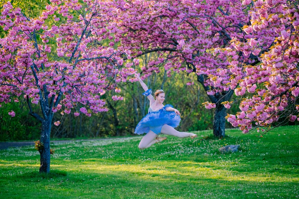 A white dancer jumps gracefully